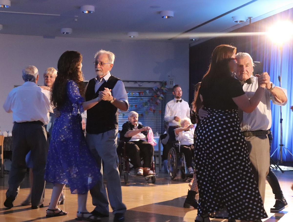 Older and younger people waltzing together at the One Community Gala